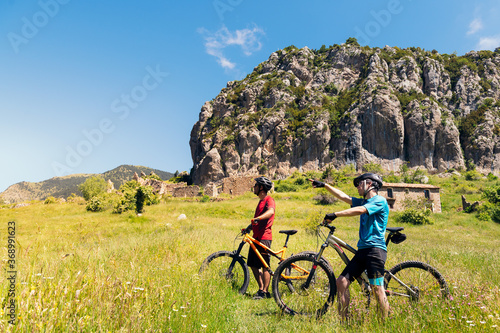 two bikers pointing the route to take with bike