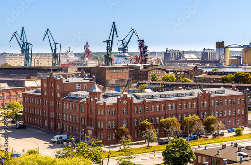 Panoramic view of Gdansk Shipyard industrial infrastructure with shipyard directorate main historic building in Gdansk, Poland