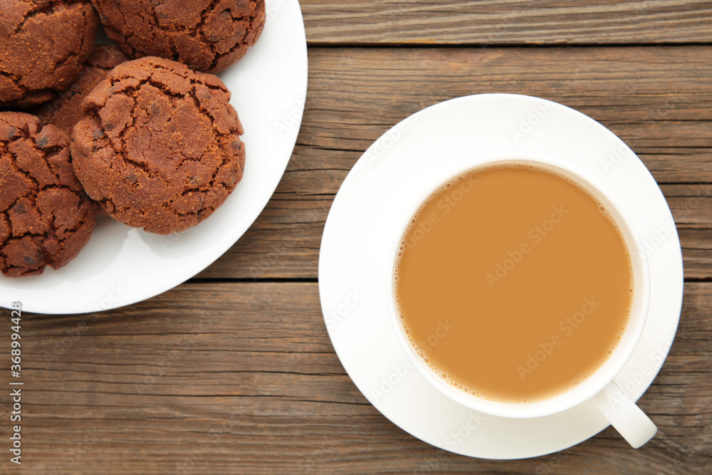 Cup of coffee and chocolate cookies on grey wooden table Cup of coffee and chocolate cookies on grey wooden table