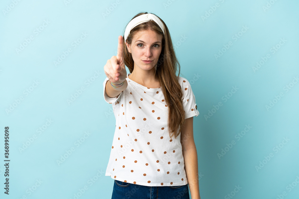 Young caucasian woman over isolated background counting one with serious expression Young caucasian woman over isolated background counting one with serious expression