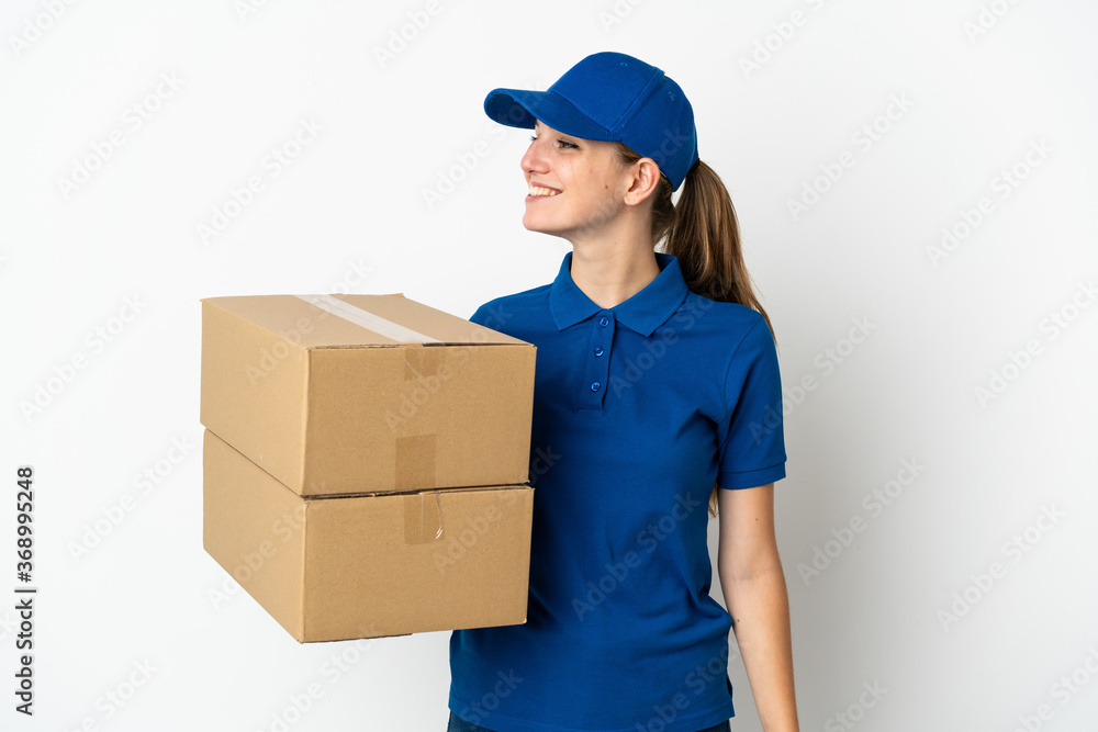 Young delivery woman isolated on white background looking side Young delivery woman isolated on white background looking side