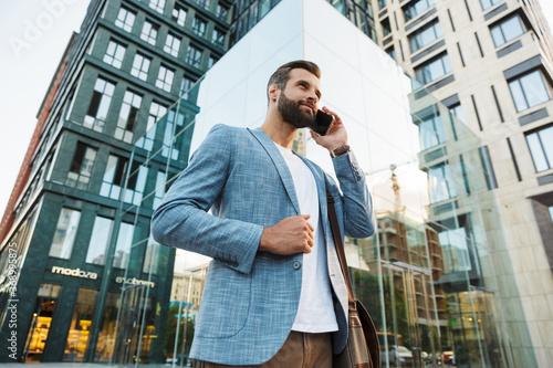 Young urban businessman on smart phone