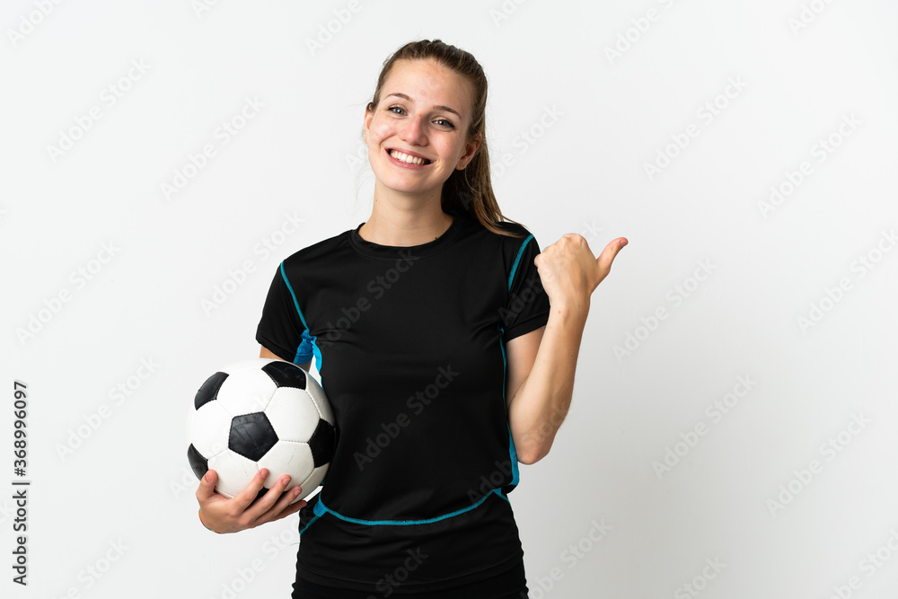 Young football player woman isolated on white background pointing to the side to present a product Young football player woman isolated on white background pointing to the side to present a product