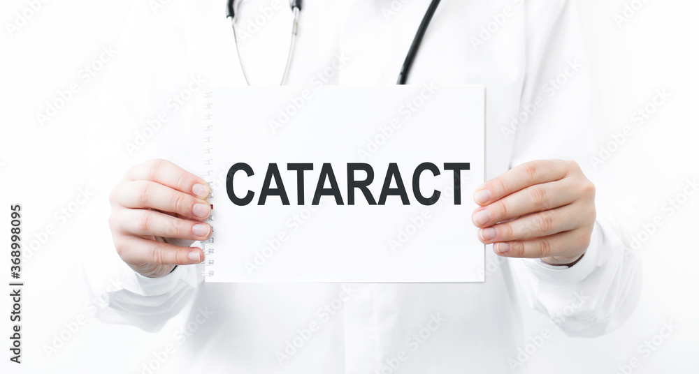 Doctor's hand shows the plate the word cataract. Medical concept. Doctor's hand shows the plate the word cataract. Medical concept.
