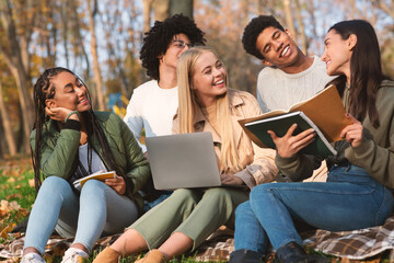 Group of friends students studying at autumn park