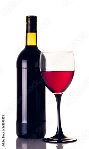 bottle and glass of red wine closeup