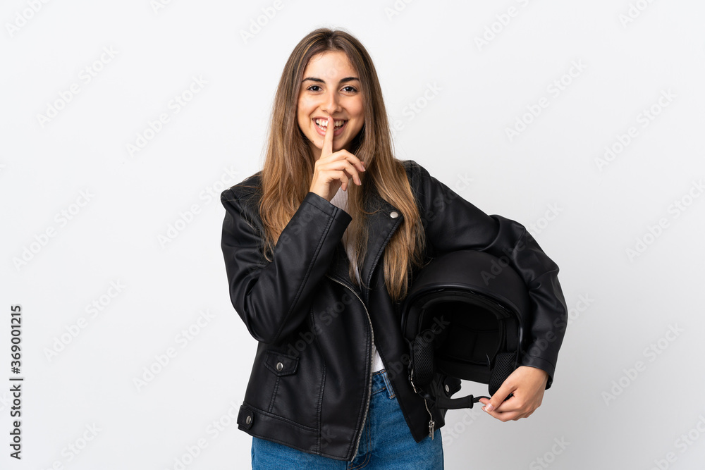 Young Woman holding a motorcycle helmet over isolated white background doing silence gesture Young Woman holding a motorcycle helmet over isolated white background doing silence gesture