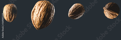 Walnut fruits (Juglans regia), nuts with a black background