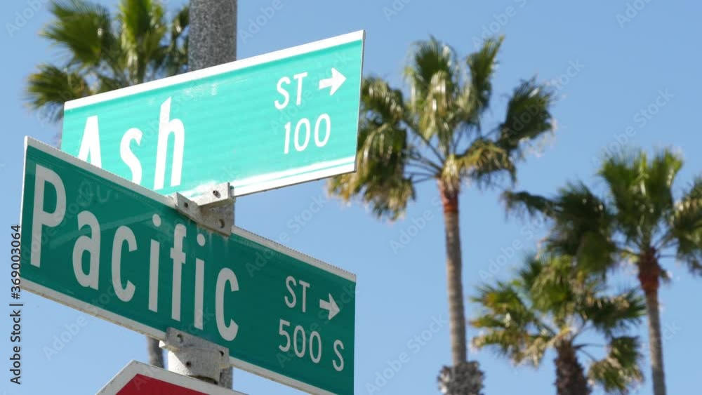 Pacific street road sign on crossroad, route 101 tourist destination, California, USA. Lettering on intersection signpost, symbol of summertime travel and vacations.Signboard in city near Los Angeles.