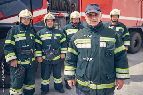 Five strong man wearing uniform while standing at the outdoors