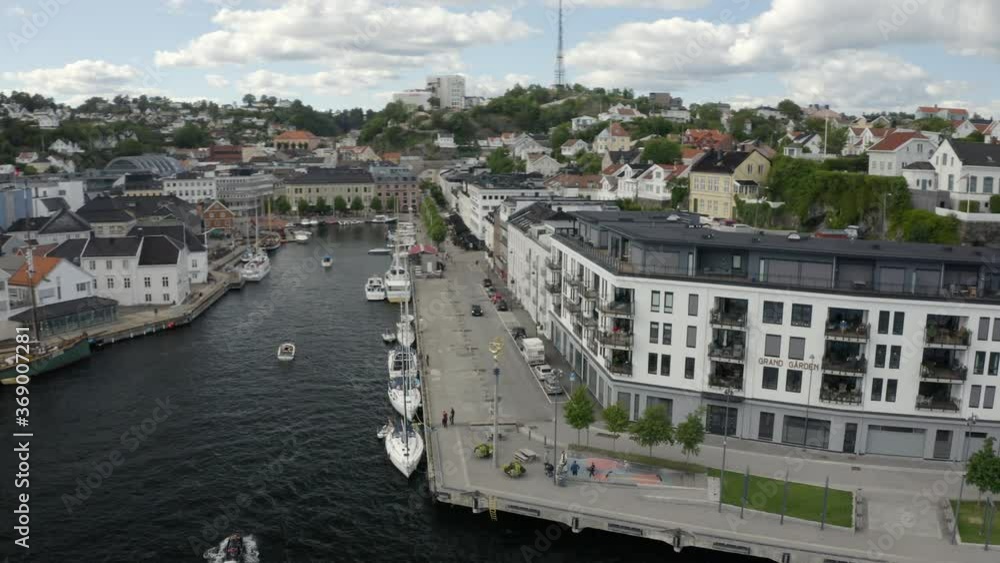 Boats Moored At The Pollen Harbour With The Grand Garden Building In Langbryggen, Arendal, Norway. - aerial drone Boats Moored At The Pollen Harbour With The Grand Garden Building In Langbryggen, Arendal, Norway. - aerial drone