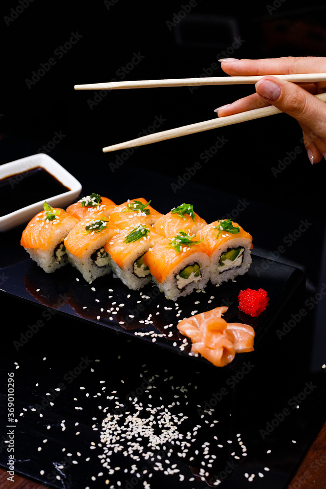 Sushi with salmon. Soy sauce, ginger, red caviar. Roles with red fish. Sushi with salmon. Soy sauce, ginger, red caviar. Roles with red fish.