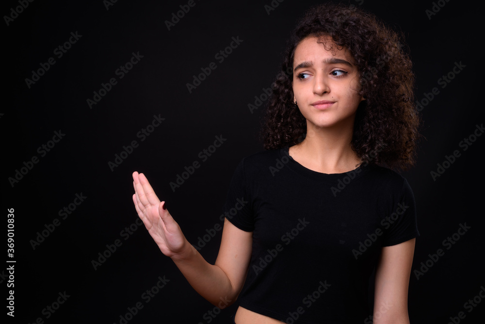 Portrait of young beautiful Persian teenage girl with curly hair Portrait of young beautiful Persian teenage girl with curly hair
