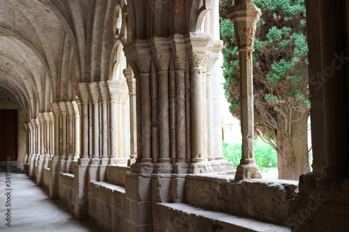 Vaulted galleries and a fragment of the courtyard of the ancient monastery of Poblet (cat. Reial Monestir de Santa Maria de Poblet) Spain.