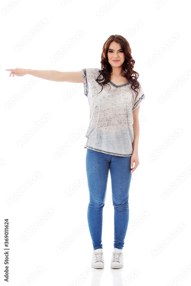 Young woman pointing to somewhere, isolated over a white background Young woman pointing to somewhere, isolated over a white background