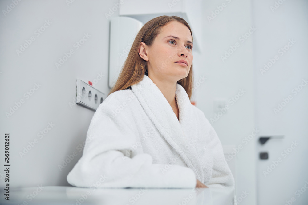 Thoughtful woman spending time at the hospital