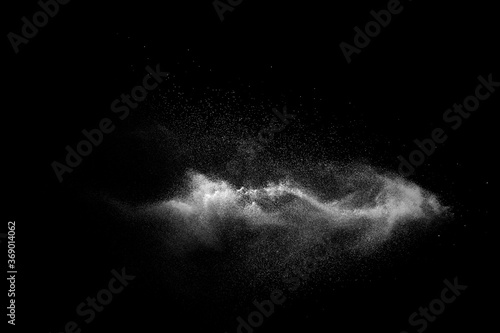 White talcume powder explosion on black background. White dust particles splash. photo