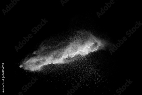 White talcume powder explosion on black background. White dust particles splash.