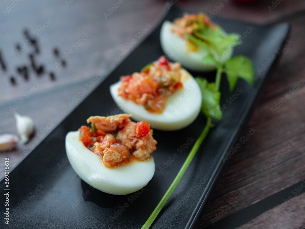 Stuffed Eggs with minced pork
Tomato,Onions,Garlic,Pepper stir well,Place the filling on a boiled egg on a Black plate,Background wood Boiled eggs Stuffed Eggs with minced pork
Tomato,Onions,Garlic,Pepper stir well,Place the filling on a boiled egg on a Black plate,Background wood Boiled eggs
