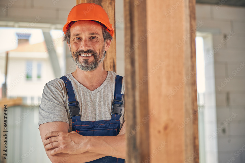 Bearded middle-aged builder looking in front of him Bearded middle-aged builder looking in front of him