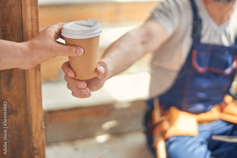 Two builders having a coffee break together Two builders having a coffee break together