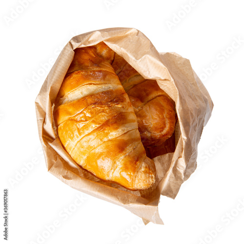 Croissants in paper bag isolated on white. Top view.