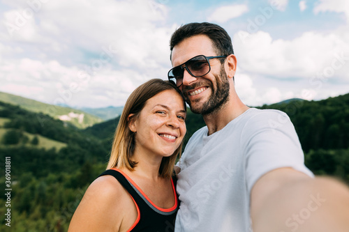 Young couple taking a selfie in the mountains