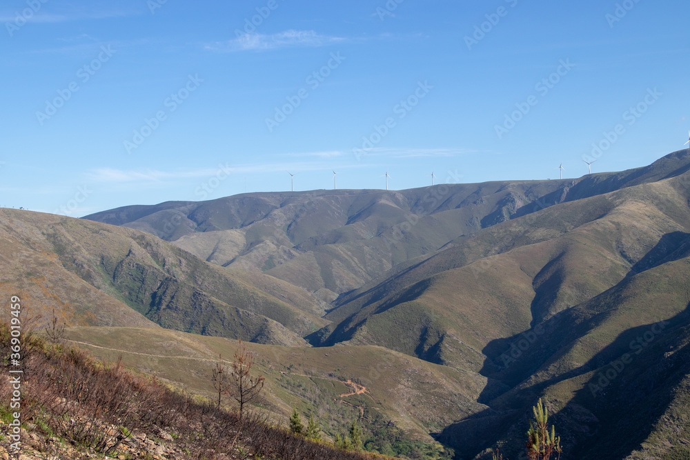 Fototapeta premium Beautiful mountain landscape, in Serra da Freita, with a wind farm on top of the mountain, located in Arouca Geopark, Portugal