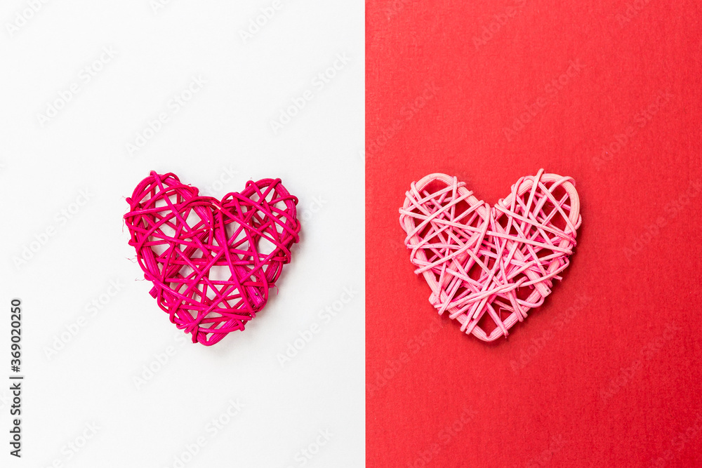 Wooden heart design on red and white paper background, love and romance symbol, valentine concept background Wooden heart design on red and white paper background, love and romance symbol, valentine concept background