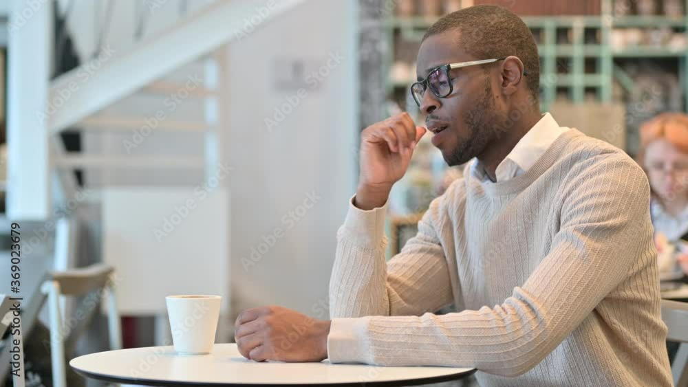 Concerned African Man Thinking in Cafe, Worrying Concerned African Man Thinking in Cafe, Worrying