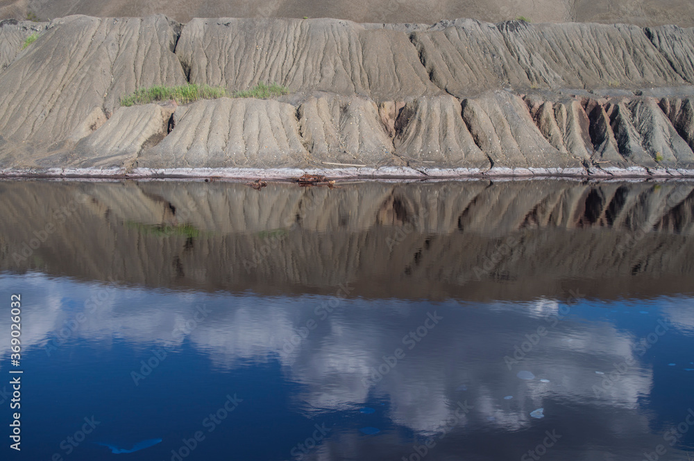 photo of a pond near a dump photo of a pond near a dump