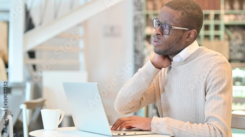Wallpaper Mural Tired African Man with Laptop having Neck Pain in Cafe Torontodigital.ca
