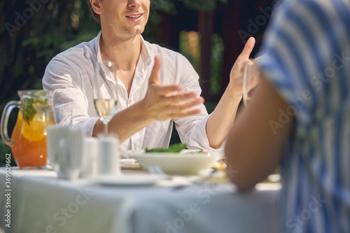 Man talking with woman while sitting at the dining table