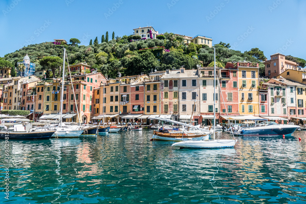 The seafront of Portofino with colorful houses and many boats