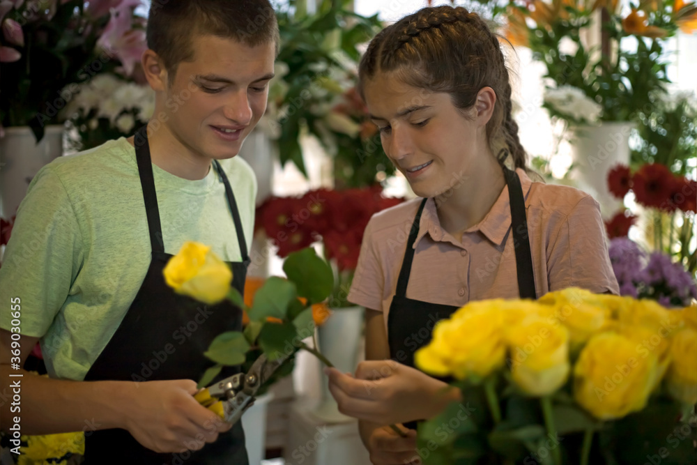 young people arrange flowers in the flower shop