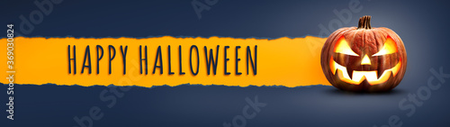 The words Happy Halloween on a textured paper tear with a Halloween Lantern, Jack O Lantern on dark blue banner background photo