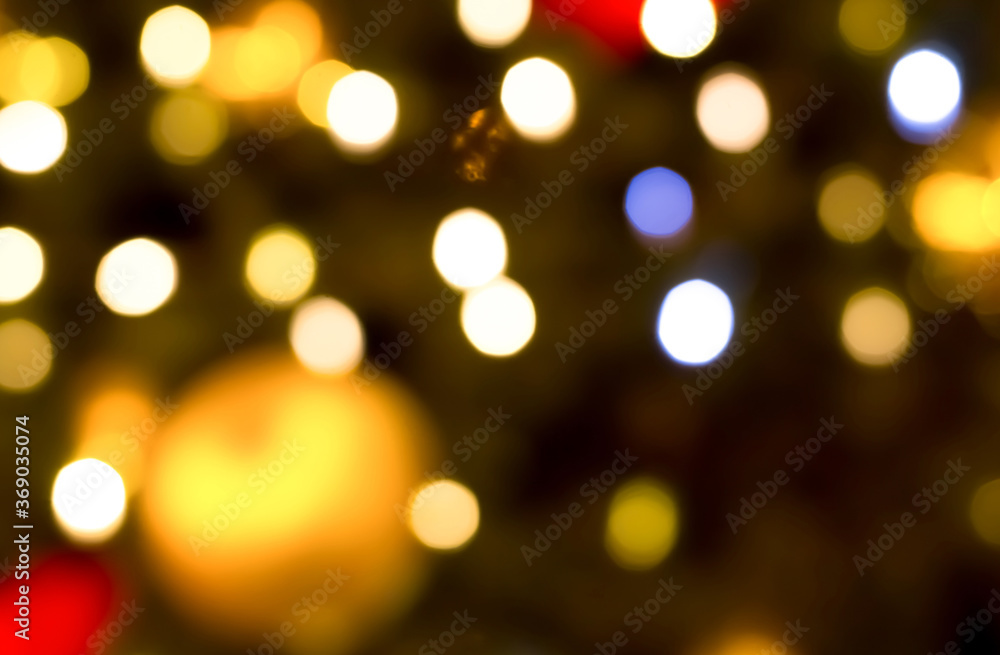 colored festive lights spots on the background of a golden ball of blues, the basis of a bright shiny Christmas