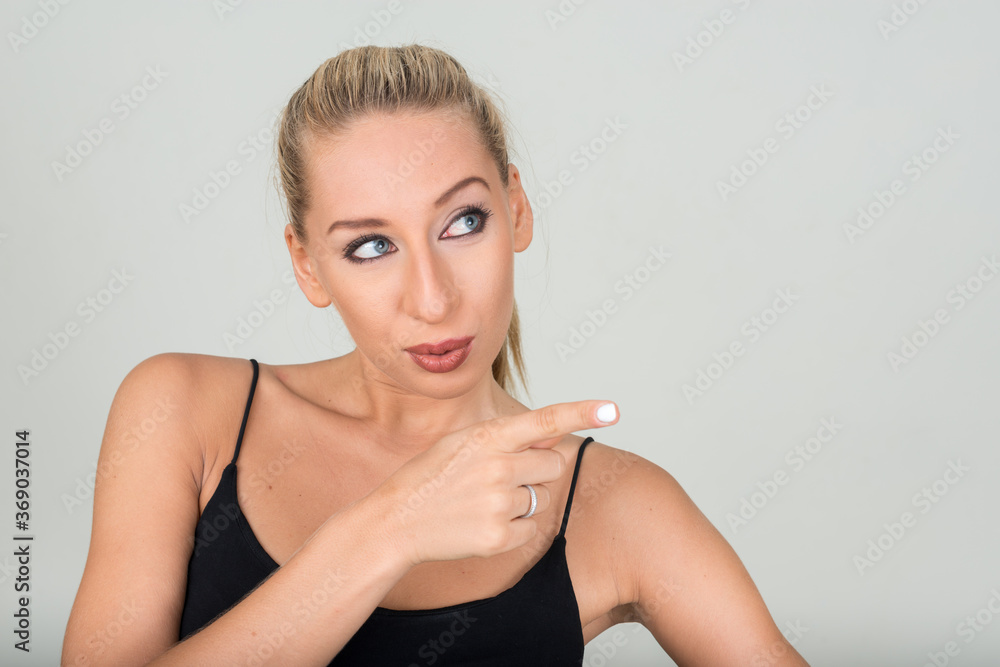 Portrait of young beautiful blonde woman against white background Portrait of young beautiful blonde woman against white background