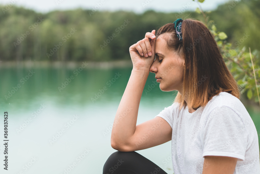 Woman closed her eyes, praying in outdoors. Hands folded in prayer concept for faith, spirituality and religion. Peace, hope, dreams concept Woman closed her eyes, praying in outdoors. Hands folded in prayer concept for faith, spirituality and religion. Peace, hope, dreams concept