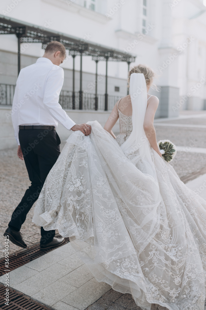 Fototapeta premium the bride and groom walk and hold hands