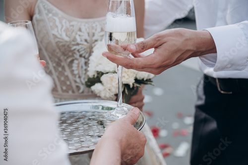 the groom takes a glass of champagne