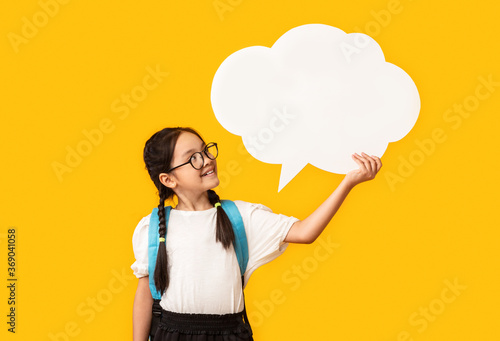 Wallpaper Mural Asian Schoolgirl Holding Blank Speech Bubble Posing Over Yellow Background Torontodigital.ca