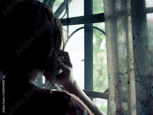 фотографія Back view of a woman receiving a foreboding call
