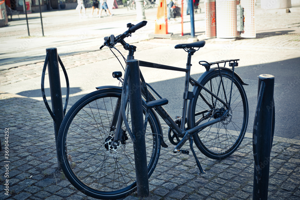 A black bicycle parked in the city