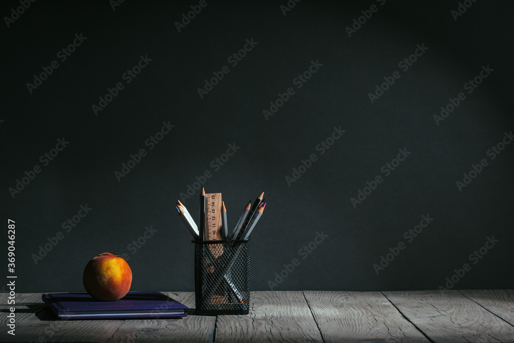 Back to school concept. stationery with fruit on the table