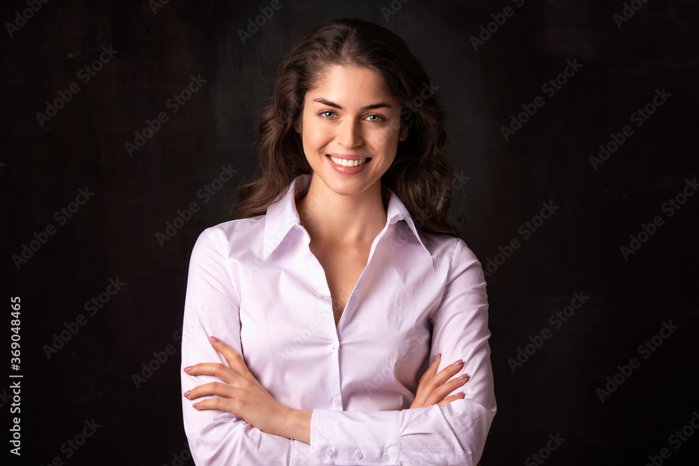 Attractive young woman studio shot while standing at isolated black background Attractive young woman studio shot while standing at isolated black background