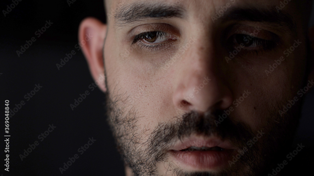 Obraz premium Portrait of worried man. Caucasian man in low key light, shallow depth of field