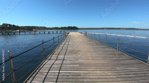 Wallpaper Mural Walking on a wooden pier in Portoroz, Slovenia on bright sunny day. Wide shot, forward dolly moving Torontodigital.ca