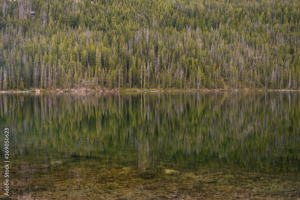 Reflecting waters of hell roaring lake in the sawtooth mountain range of central Idaho Reflecting waters of hell roaring lake in the sawtooth mountain range of central Idaho
