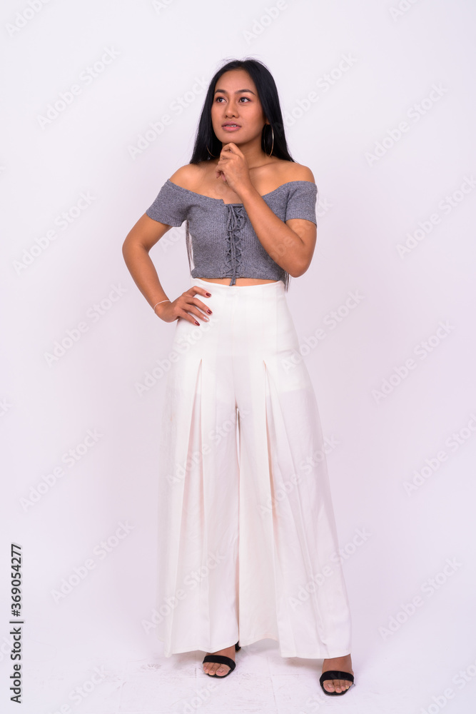 Young beautiful Asian woman against white background